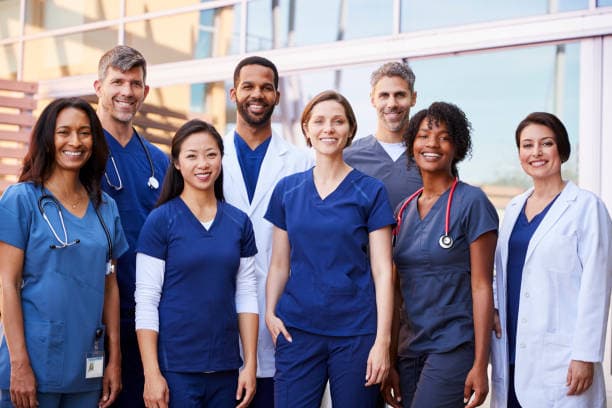 Healthcare team standing together outside a medical facility